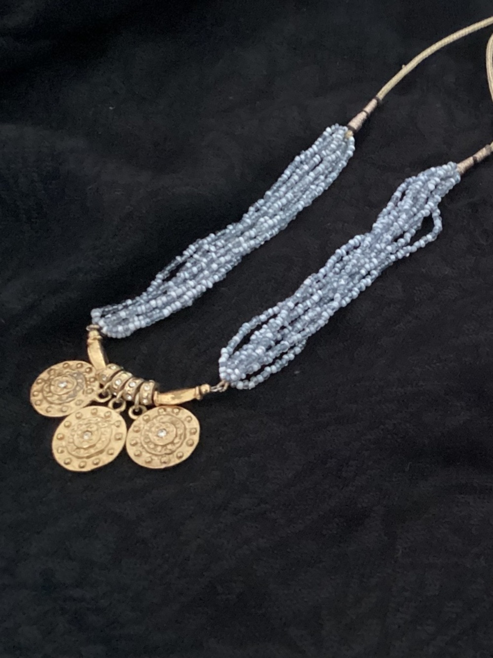 India beaded baby blue with gold plated coins..very cool necklace. Excellent